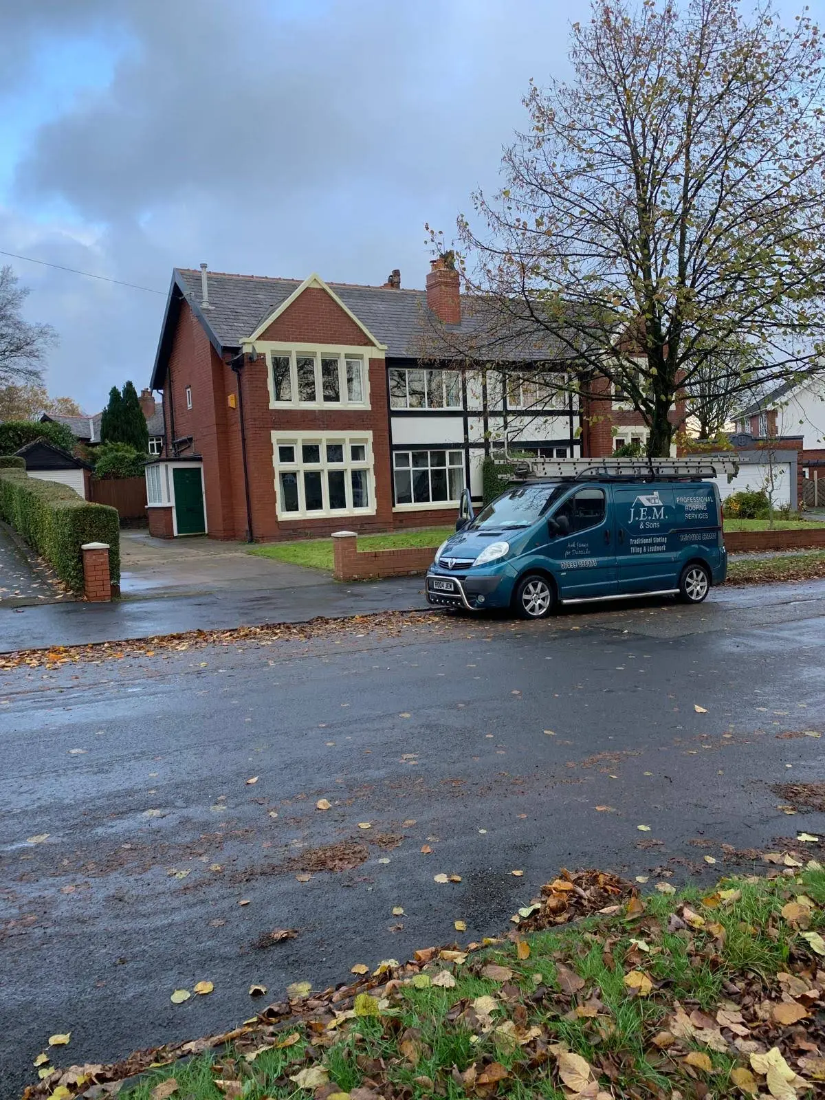 J.E.M Roofing van outside a brick family home